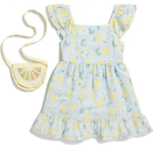 Ensemble robe imprimé citrons sur font bleu pale  et sac a main tranche de citron.
