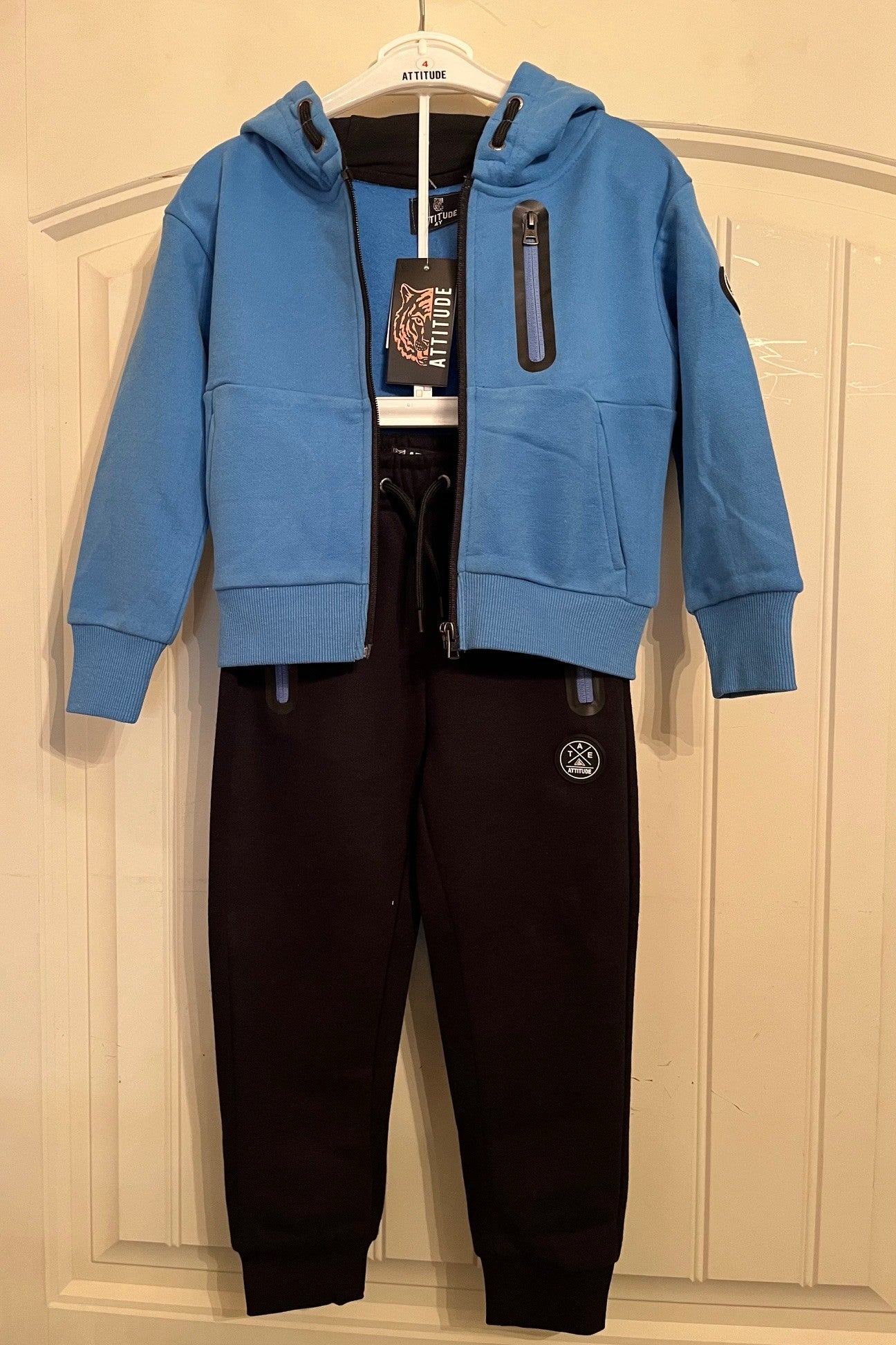 Ensemble jogging sport-veste bleu a capuche zippé et jogging noir.